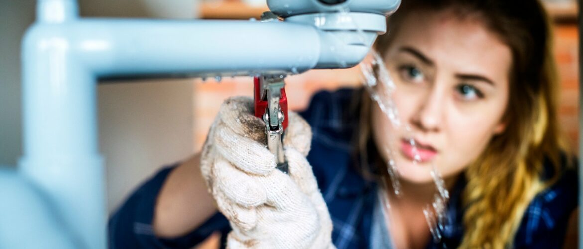 Woman fixing kitchen sink Woman fixing kitchen sink
